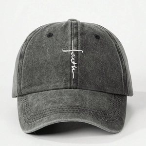 Macro detail of white 'faith' cross embroidery on dark grey washed cotton baseball cap