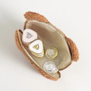 Interior view of brown teddy plush bear makeup bag with multiple cosmetic bottles