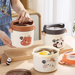 Detail of cute bear printed lunch box with portable handle on a wooden table
