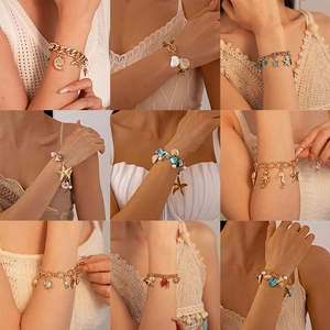 Assorted ocean-themed bracelets featuring starfish, turtles, and pearls in gold and silver