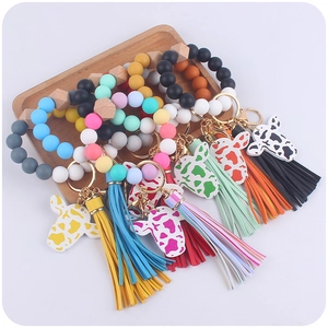 Macro shot of colorful silicone bead bracelets with cow head charms and long tassels