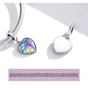 Macro shot of 925 sterling silver heart charm with colorful fish scale texture and polish