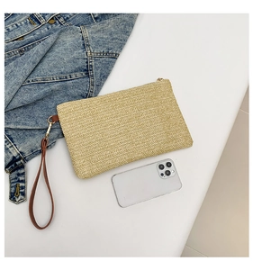 Beige straw envelope clutch with brown wristlet strap and chic herringbone weave detail