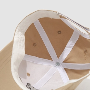Detail view showing internal structure of cotton baby baseball cap with sweatband