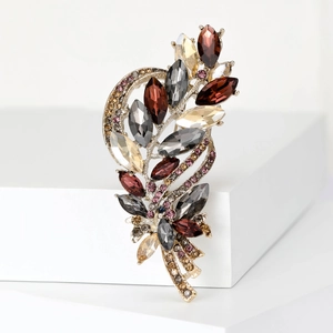 Detailed view of crystal wheat brooch with champagne and coffee stones on white base