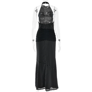 Detail of elegant black polka dot maxi dress featuring backless halter neck design