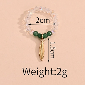 Beaded ring detail with transparent facets, green accents and gold leaf pendant specs