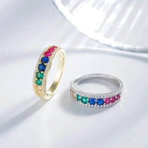 Macro shot of colorful gemstone pave rings with 925 silver stamp and sparkling diamonds