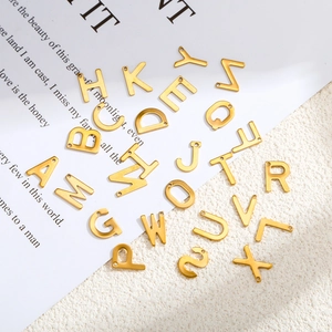 Close-up of gold-plated stainless steel letter charms for DIY necklaces and bracelets