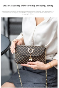 Detail of a small chain bag featuring vintage round patterns and a golden cat-head pearl charm
