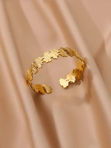 Détail du bracelet ouvert en acier inoxydable plaqué or 18K avec motifs papillons