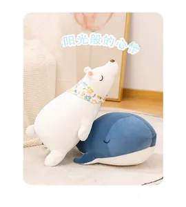 Macro shot of cute plush polar bear and blue whale toys with soft velvet texture