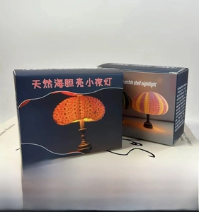 Detail view of mini urchin night light packaging in orange and purple shell designs