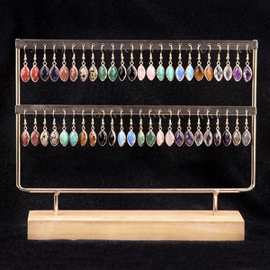 Marquise cut semi-precious amethyst and colorful stone earrings on a tiered jewelry display