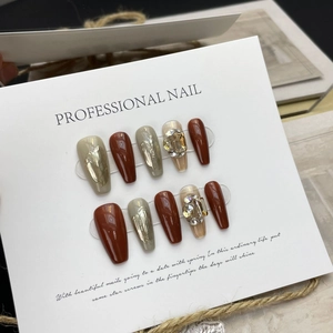 Handmade coffin press-on nails with dark brown, glitter, and rhinestone accents