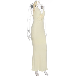 Detailed view of cream halter neck maxi dress featuring deep V-neck and twist knot detail
