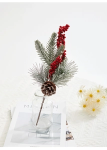 Detail of Christmas spray with red berries, pine cones and snow-covered pine needles in a vase