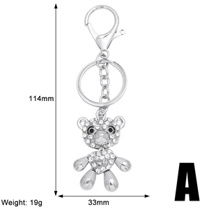 Silver bear keychain with white rhinestones and heart detail, dimensions 114mm by 33mm
