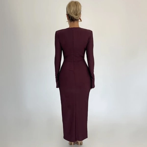 Detailed back view of slim-fit burgundy maxi dress with concealed zipper and shoulder pads