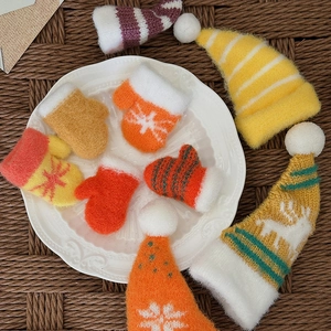 Set of colorful mini knitted Christmas hats and mittens for DIY crafts and decor