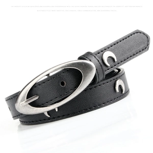 Detail of black pebbled leather belt with vintage silver crescent moon studs and oval buckle