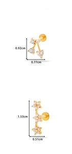 Detailed view of cherry and floral gold ear studs with cubic zirconia and flat back design