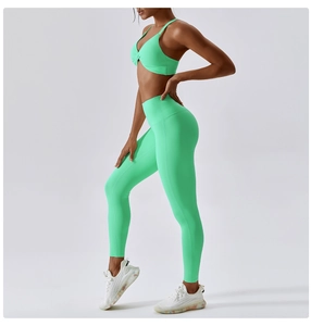 Detail view of mint green high-waisted yoga leggings and seamless sports bra set