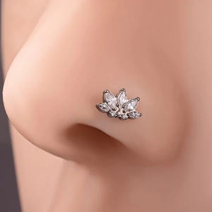 Silver G23 titanium lotus nose stud with white zircon crystals shown on a model nose