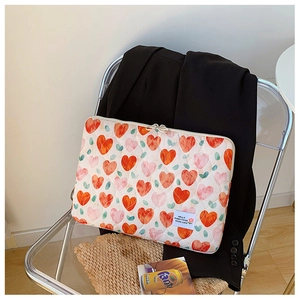 Detailed shot of quilted heart pattern laptop bag on a transparent chair with blazer
