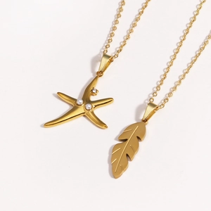 Close-up of golden starfish and feather necklaces with pearl and diamond accents