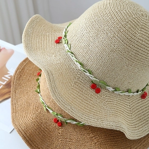 Women straw sun hat with woven vine and cherry decor in cream and brown colors