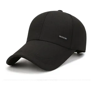 Detail of black baseball cap side with silver metal Sport badge and twill fabric texture