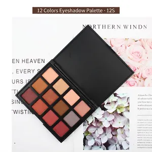 12-color eyeshadow palette with earth tones, matte and pearlescent textures on a magazine