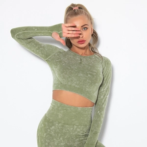 Detail of acid wash texture on grey-green yoga top with thumbholes and ribbed cuffs