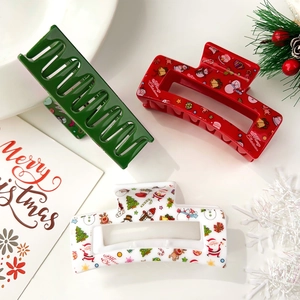 Christmas hair claws with reindeer and snowman prints in festive red, green and white colors