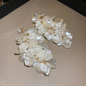 Detailed macro view of cascading white shell-leaf tassels and sparkling zircon studs