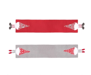 Flat lay of red and grey knitted Christmas table runners with gnome decorative elements