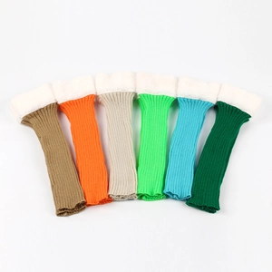 Close-up of six colorful knit leg warmers with white faux fur lining and plush trim