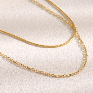 Detail view of 18K gold plated double layer necklace with snake and O-link chains