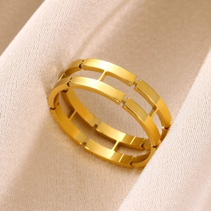 Detailed close-up of 18K gold-plated hollow geometric chain ring on silk fabric