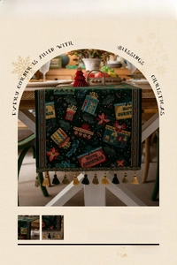 Close-up of green jacquard Christmas table runner with festive tassels and patterns
