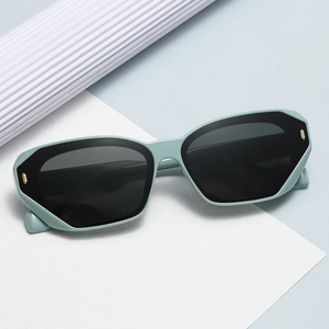Modern mint green geometric sunglasses with dark lenses and gold metal accents