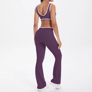 Back view of high-waist flared yoga pants and sports bra set in deep purple with white piping