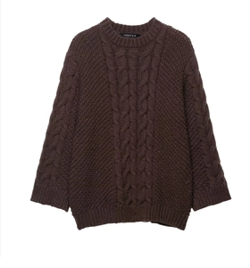 Detail of dark brown chunky cable knit texture on a crewneck sweater with flare sleeves