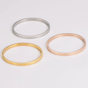 Three minimalist butterfly stainless steel bracelets in gold, silver, and rose gold colors