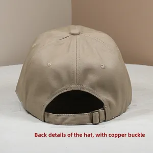 Detail view of khaki baseball cap with adjustable vintage bronze buckle on the back