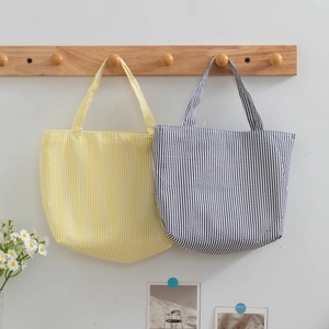 Minimalist summer canvas tote bags in yellow and navy blue stripes with U-shaped base