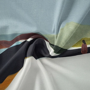 Detailed macro view showing the silky texture and artistic landscape print of the tapestry