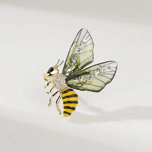 Exquisite bee brooch with gold finish, sparkling crystals and green glittery wings