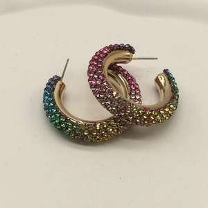 Detailed close-up of C-shaped hoop earrings with multi-color gradient rhinestones